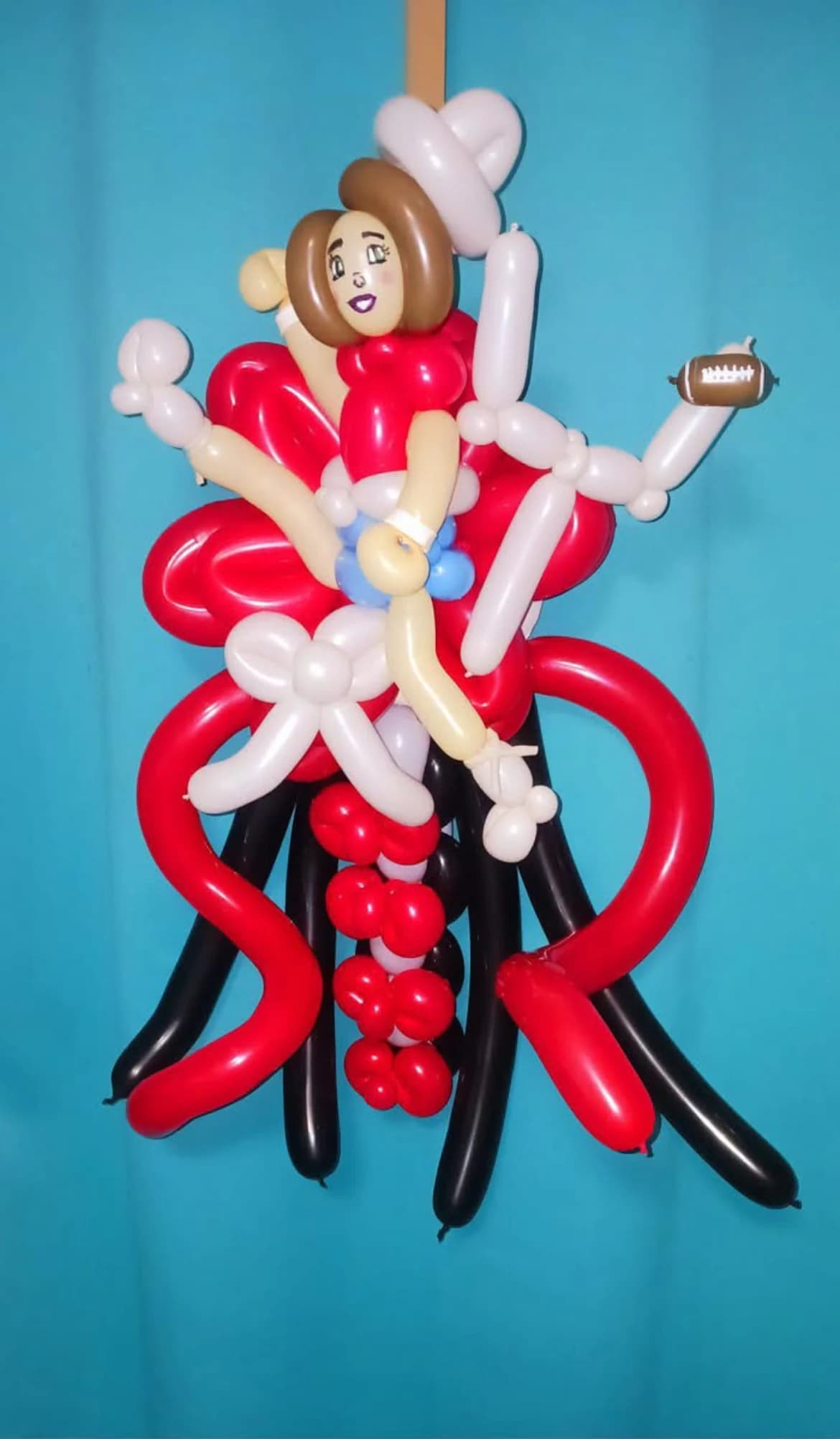 Football-themed balloon caricature in red, white and black