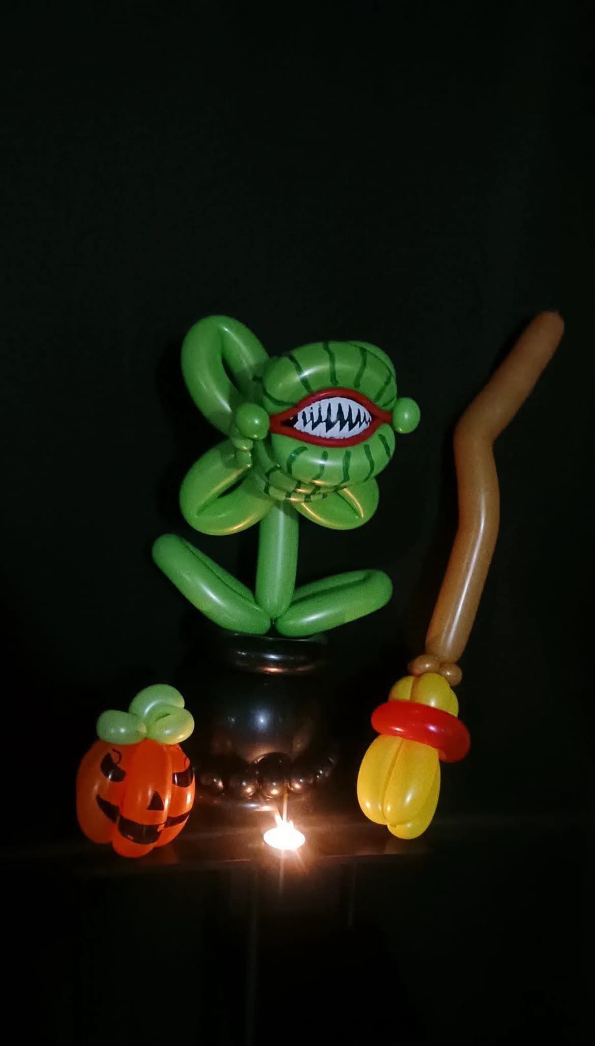 Halloween balloon display with a monster plant, pumpkin and broom
