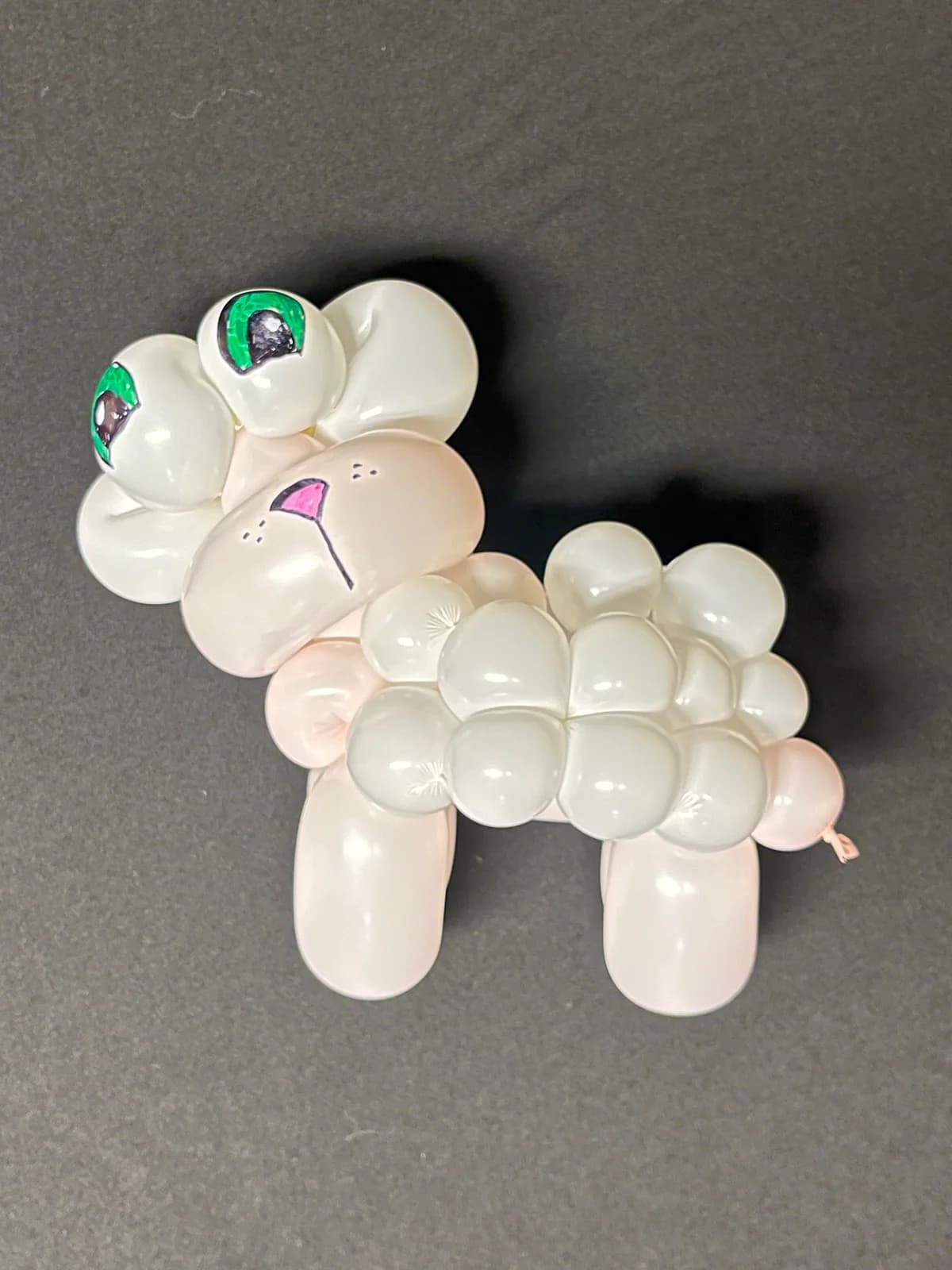 White balloon lamb with green eyes