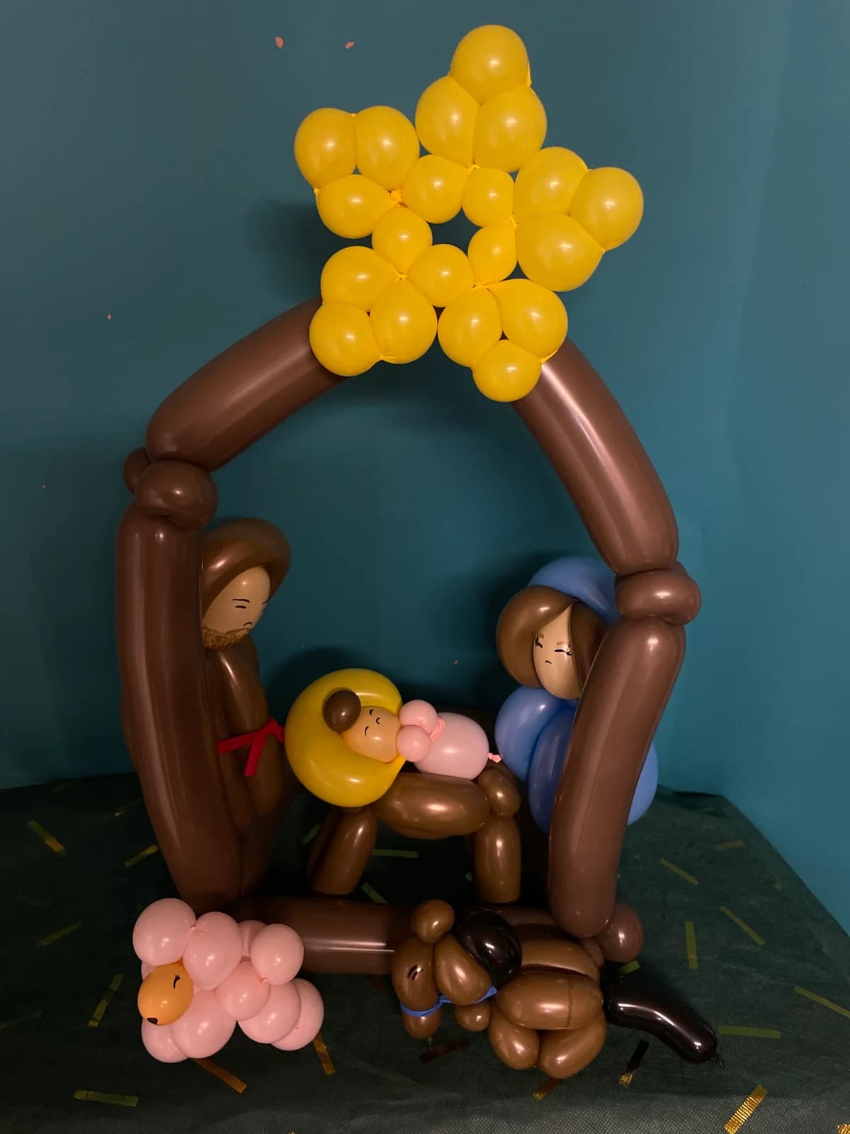 Balloon nativity scene under a yellow star