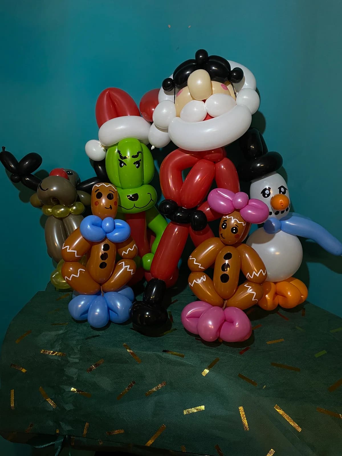 Santa balloon sculpture surrounded by colorful gifts