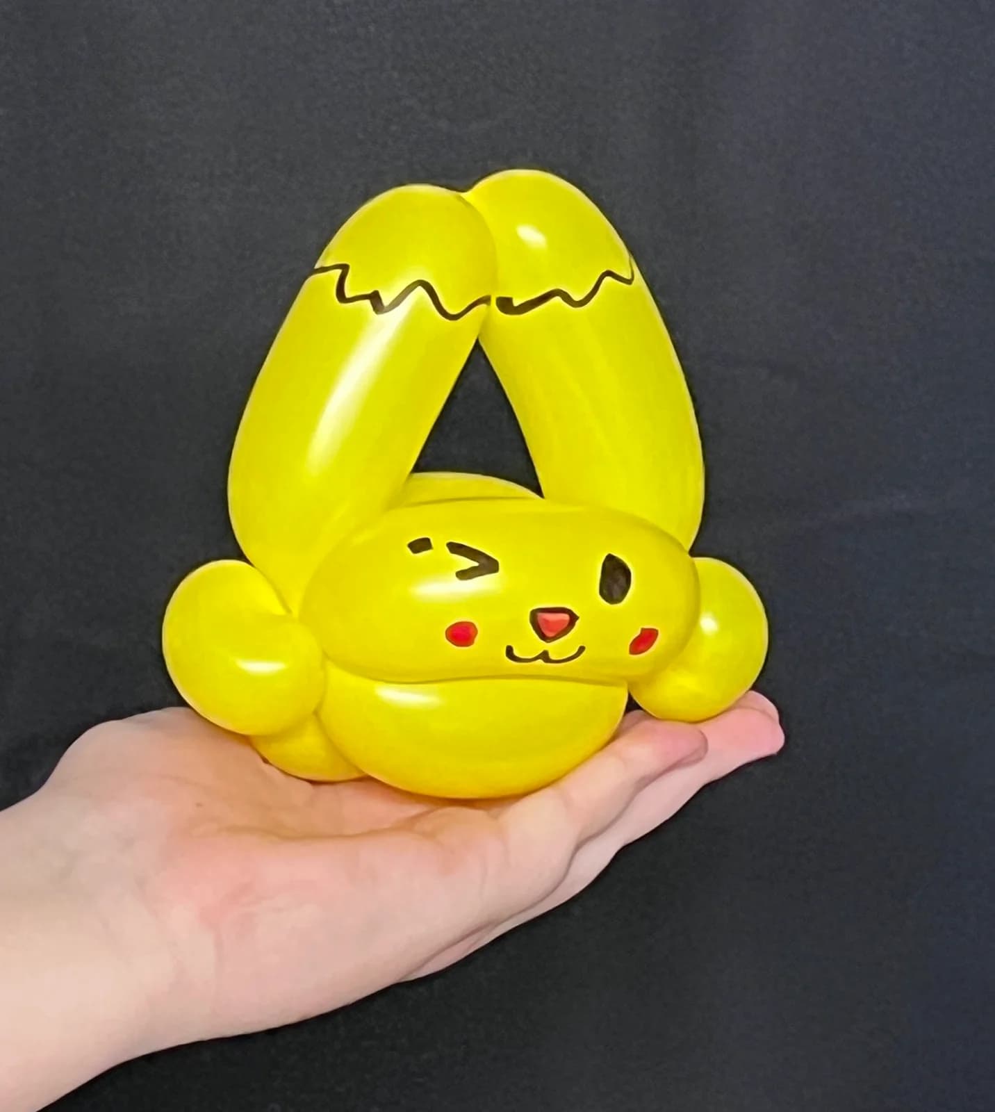 Yellow character balloon with pointed ears